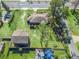 Aerial view of a property with two buildings and a large yard at 703 & 705 Cleveland Ave, Wildwood, FL 34785