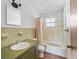 Simple bathroom with shower/tub and green vanity at 703 & 705 Cleveland Ave, Wildwood, FL 34785