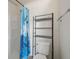 Clean bathroom with shower and shelving unit at 703 & 705 Cleveland Ave, Wildwood, FL 34785