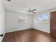 Bright bedroom with wood flooring and two windows at 703 & 705 Cleveland Ave, Wildwood, FL 34785