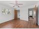 Bright bedroom with wood-look floors and ceiling fan at 703 & 705 Cleveland Ave, Wildwood, FL 34785