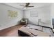 Simple bedroom with wood flooring, ceiling fan, and window at 703 & 705 Cleveland Ave, Wildwood, FL 34785