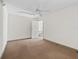 Spacious bedroom with neutral walls and carpet flooring at 703 & 705 Cleveland Ave, Wildwood, FL 34785