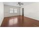 Hardwood floor bedroom with closet and ceiling fan at 703 & 705 Cleveland Ave, Wildwood, FL 34785