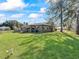 Ranch-style home with large backyard and mature trees at 703 & 705 Cleveland Ave, Wildwood, FL 34785