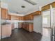 Kitchen with wood cabinets and dark laminate floors at 703 & 705 Cleveland Ave, Wildwood, FL 34785