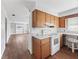 Simple kitchen with wood cabinets and white appliances at 703 & 705 Cleveland Ave, Wildwood, FL 34785