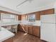 Galley kitchen with wood cabinets and laminate countertops at 703 & 705 Cleveland Ave, Wildwood, FL 34785