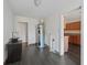 Laundry room with water heater and dark laminate floors at 703 & 705 Cleveland Ave, Wildwood, FL 34785