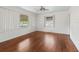 Bright living room with hardwood floors and large windows at 703 & 705 Cleveland Ave, Wildwood, FL 34785