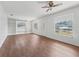 Spacious living room featuring built-in shelving and wood-look floors at 703 & 705 Cleveland Ave, Wildwood, FL 34785