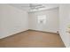 Small office with carpet, window, and ceiling fan at 703 & 705 Cleveland Ave, Wildwood, FL 34785