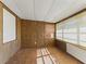Sunroom with wood paneling and tile flooring at 703 & 705 Cleveland Ave, Wildwood, FL 34785