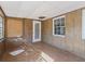 Sunroom features wood paneling, tile floors, and multiple windows at 703 & 705 Cleveland Ave, Wildwood, FL 34785