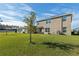 Spacious backyard with grassy area and patio at 8511 Triumph Cir, Wildwood, FL 34785