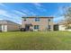 Large backyard with patio and grassy area at 8511 Triumph Cir, Wildwood, FL 34785