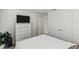 Bedroom with dresser, closet, and TV at 8511 Triumph Cir, Wildwood, FL 34785