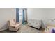 Bedroom with crib, recliner, and changing table at 8511 Triumph Cir, Wildwood, FL 34785