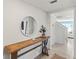 Entryway with a wooden console table and a large round mirror at 8511 Triumph Cir, Wildwood, FL 34785
