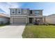 Two story house with a two car garage at 8511 Triumph Cir, Wildwood, FL 34785