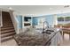 Modern kitchen island with granite countertop and double sink, overlooking living room at 8511 Triumph Cir, Wildwood, FL 34785
