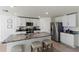Modern kitchen with white cabinets, granite countertops, and stainless steel appliances at 8511 Triumph Cir, Wildwood, FL 34785