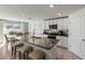 Modern kitchen with white cabinets, granite countertops, and stainless steel appliances at 8511 Triumph Cir, Wildwood, FL 34785