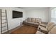 Living room with beige reclining sofas and a neutral rug at 8511 Triumph Cir, Wildwood, FL 34785