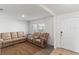 Living room with beige reclining sofas and a neutral rug at 8511 Triumph Cir, Wildwood, FL 34785