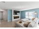 Living room with fireplace and comfortable seating at 8511 Triumph Cir, Wildwood, FL 34785