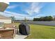 Relaxing patio with fire pit and grill at 8511 Triumph Cir, Wildwood, FL 34785
