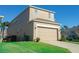 House exterior with two-car garage and landscaping at 904 Cloverwood Way, Winter Garden, FL 34787