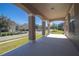 Covered porch with arched columns and neighborhood view at 904 Cloverwood Way, Winter Garden, FL 34787