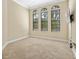 Bedroom with three windows and wall-mounted TV at 9339 San Jose Blvd, Howey In The Hills, FL 34737