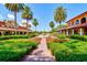 Courtyard with fountain, lush landscaping, and Spanish-style buildings at 9339 San Jose Blvd, Howey In The Hills, FL 34737