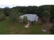 Single-story home with a large yard, located in a wooded area at 9622 Dr Baker Rd, Groveland, FL 34736