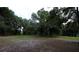 Spacious backyard with mature trees and grassy area at 9622 Dr Baker Rd, Groveland, FL 34736