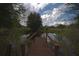 Serene backyard pond with wooden footbridge, offering a peaceful retreat at 9622 Dr Baker Rd, Groveland, FL 34736