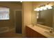 Double vanity bathroom with large mirror, shower, and garden tub at 9622 Dr Baker Rd, Groveland, FL 34736