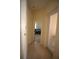 Bright hallway with tile flooring, leading to bedroom and patio at 9622 Dr Baker Rd, Groveland, FL 34736