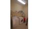 Laundry room with washer, dryer and shelving at 9622 Dr Baker Rd, Groveland, FL 34736