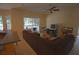 Spacious living room featuring a large sectional sofa and sliding glass doors at 9622 Dr Baker Rd, Groveland, FL 34736