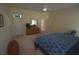 Spacious main bedroom with dresser, TV, and ensuite bathroom access at 9622 Dr Baker Rd, Groveland, FL 34736