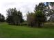 Landscaped yard with lush grass and mature trees at 9622 Dr Baker Rd, Groveland, FL 34736
