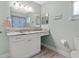 Bathroom with granite countertop and white cabinets at 10662 Se 174Th Loop, Summerfield, FL 34491