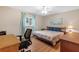 Bright bedroom featuring a king-size bed and home office at 10662 Se 174Th Loop, Summerfield, FL 34491
