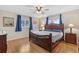 Main bedroom with wood flooring and large bed at 10662 Se 174Th Loop, Summerfield, FL 34491
