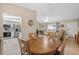 Bright dining area with wood table and chairs, open to kitchen at 10662 Se 174Th Loop, Summerfield, FL 34491