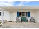 Charming front porch with blue shutters and comfortable rocking chairs at 10662 Se 174Th Loop, Summerfield, FL 34491