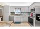 Modern kitchen with stainless steel appliances and granite countertops at 10662 Se 174Th Loop, Summerfield, FL 34491